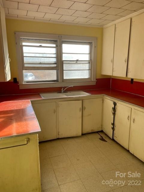 860 Padgett Road Union Mills, NC 28167 - Photo 6 of 14 a view of a kitchen with a sink wooden cabinets and a window