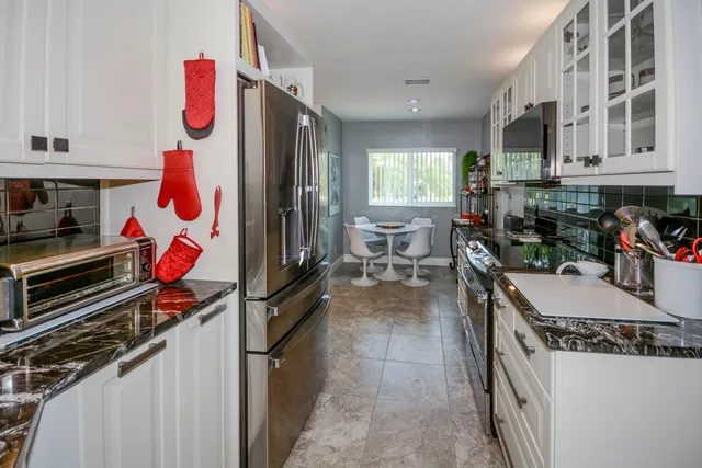 a kitchen with stainless steel appliances granite countertop a stove and a refrigerator
