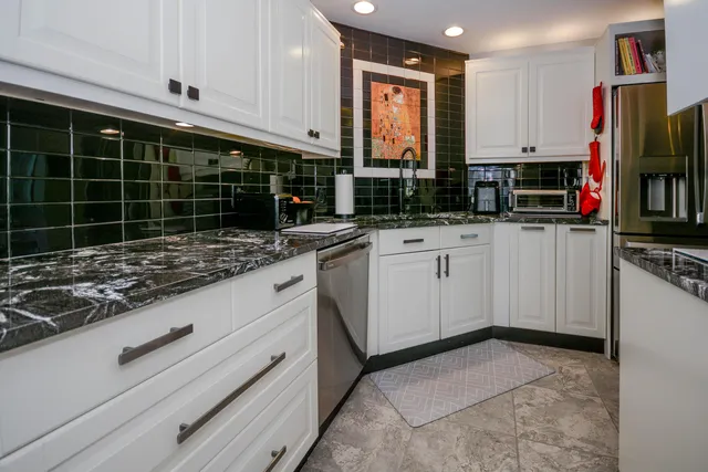 a kitchen with appliances a sink and cabinets
