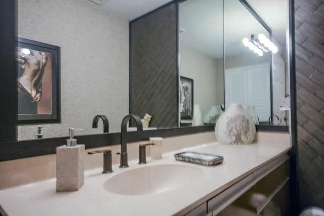 a bathroom with a double vanity sink and a mirror
