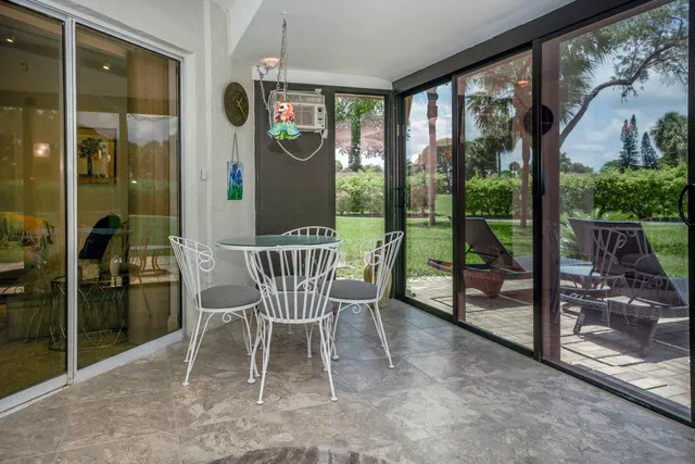 a view of a porch with chairs and backyard