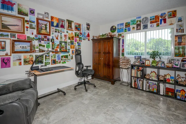 a room with furniture a rug toys and a book shelf