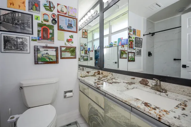 a bathroom with a sink a toilet and a shower curtain
