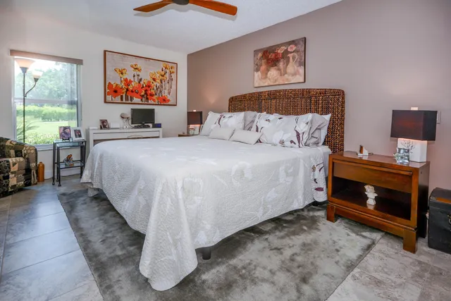 a spacious bedroom with a bed and a desk