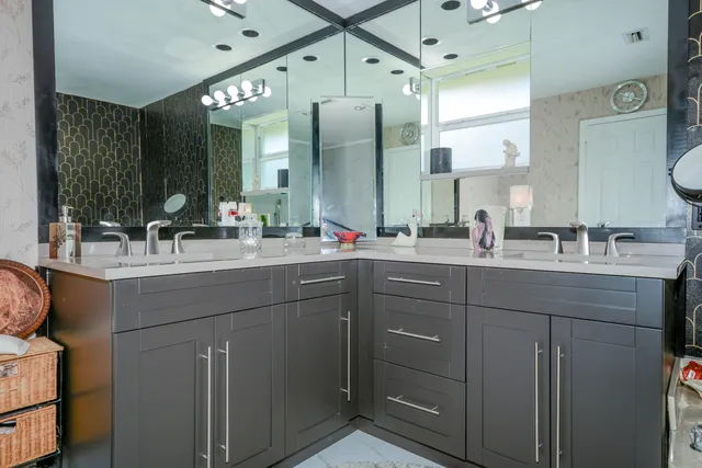 a bathroom with a double vanity sink and a mirror