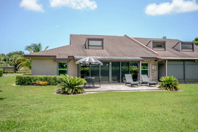 a front view of house with yard and outdoor seating