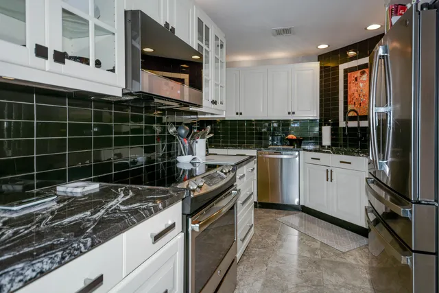 a kitchen with a sink stove and cabinets
