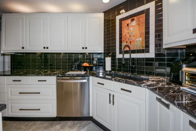 a kitchen with appliances a sink and cabinets
