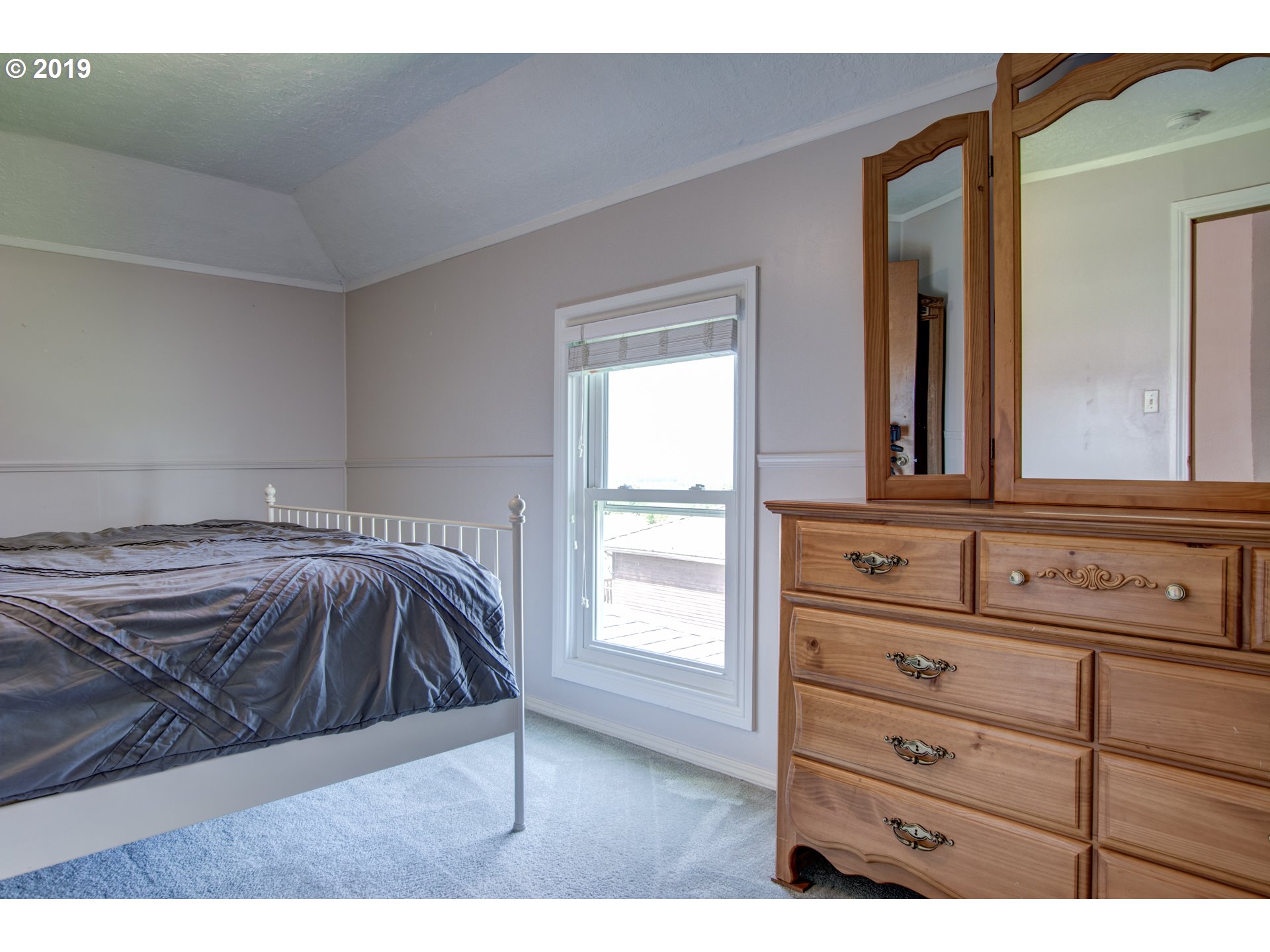 823 South Hillhurst Road Ridgefield, WA 98642 - Photo 26 of 31 a bedroom with a bed and a mirror