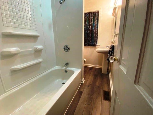 200 Park Avenue Warren, PA 16365 - Photo 12 of 12 a bathroom with a tub a sink and wooden floor