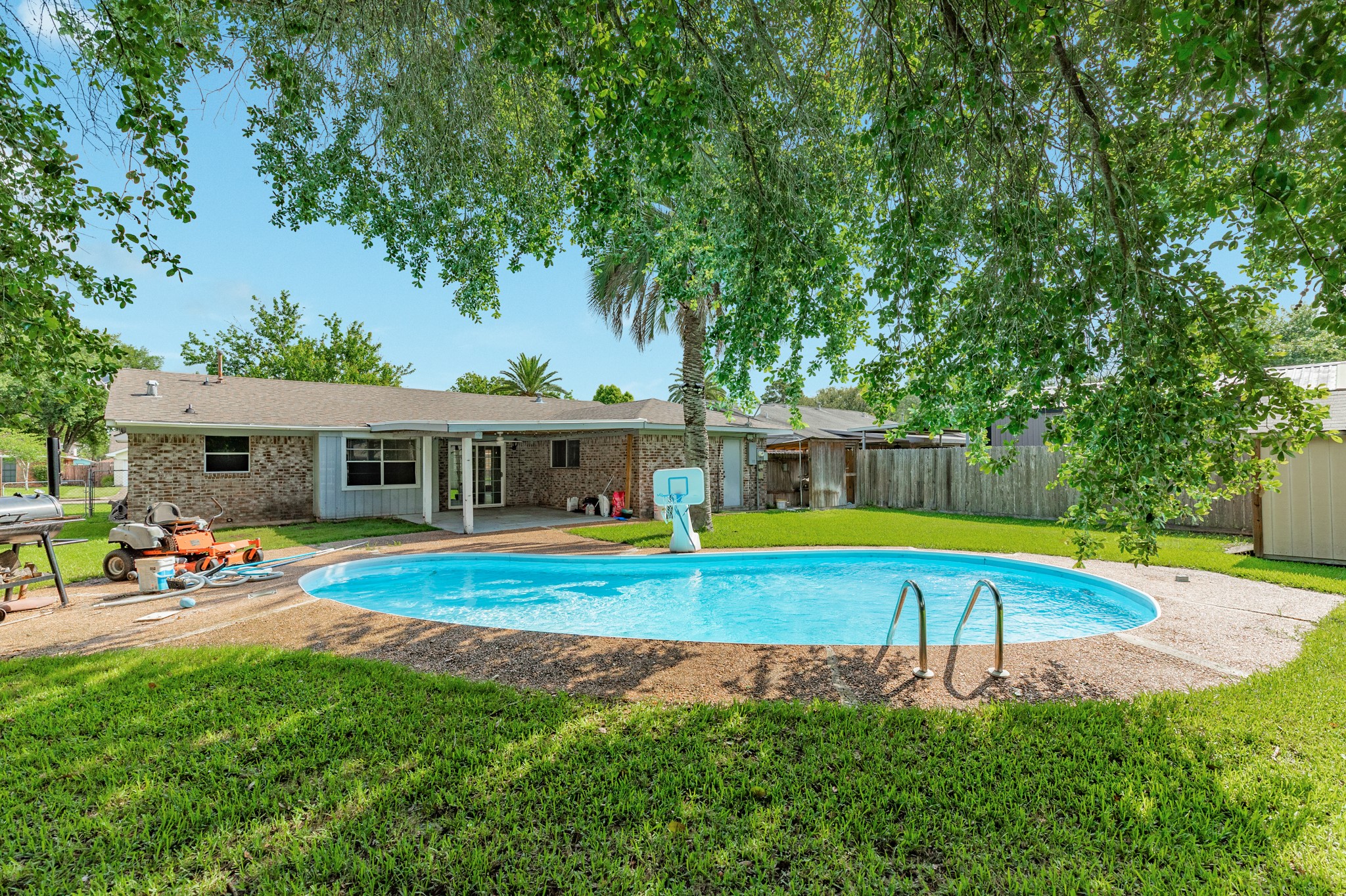128 Houston Street Angleton, TX 77515 - Photo 3 of 25 a view of a house with pool and a yard
