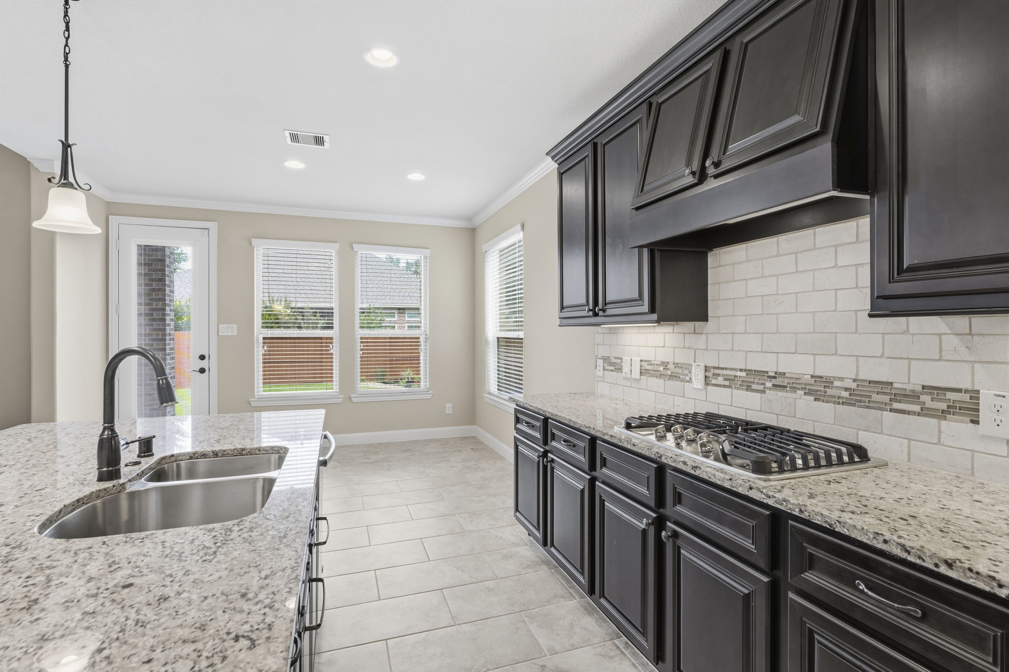 25210 Gaddis Oaks Drive Spring, TX 77389 - Photo 11 of 50 a kitchen with stainless steel appliances granite countertop a sink stove and cabinets