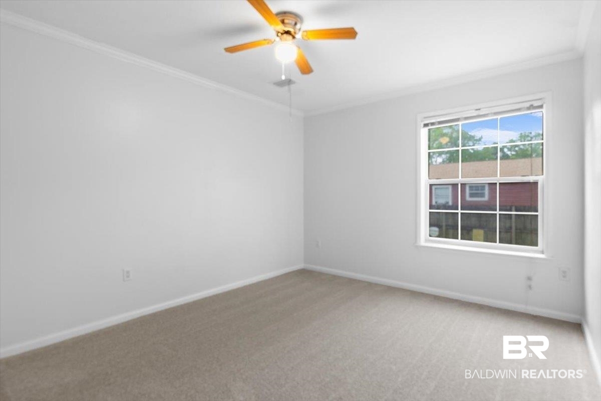 6971 March Road Theodore, AL 36582 - Photo 10 of 26 Unfurnished room with ornamental molding, baseboards, and light colored carpet
