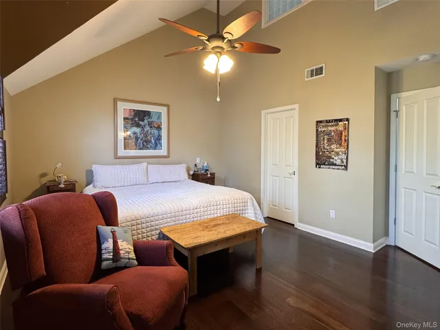 a bedroom with furniture and wooden floor