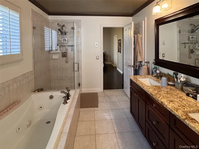 a spacious bathroom with a granite countertop tub sink and mirror