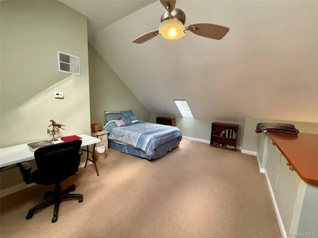 a bedroom with furniture and a chandelier fan