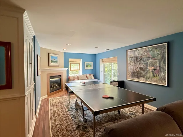 a living room with a table chairs and a fireplace