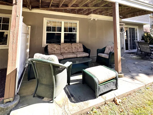 a balcony with furniture and a potted plant