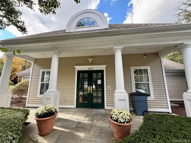 a front view of a house with outdoor seating