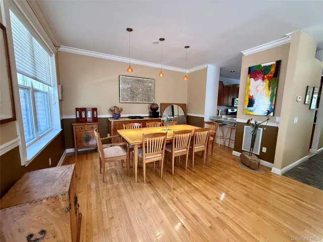 a view of a dining room with furniture and wooden floor