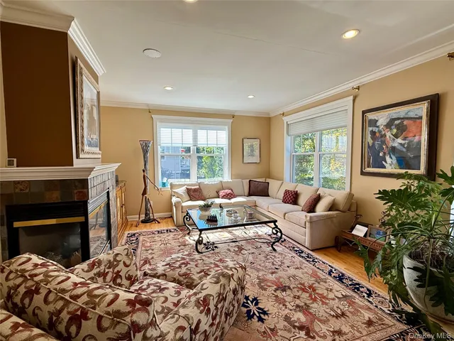 a living room with furniture fireplace and window