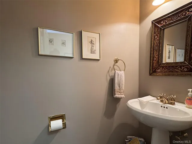 a bathroom with a sink mirror and toilet