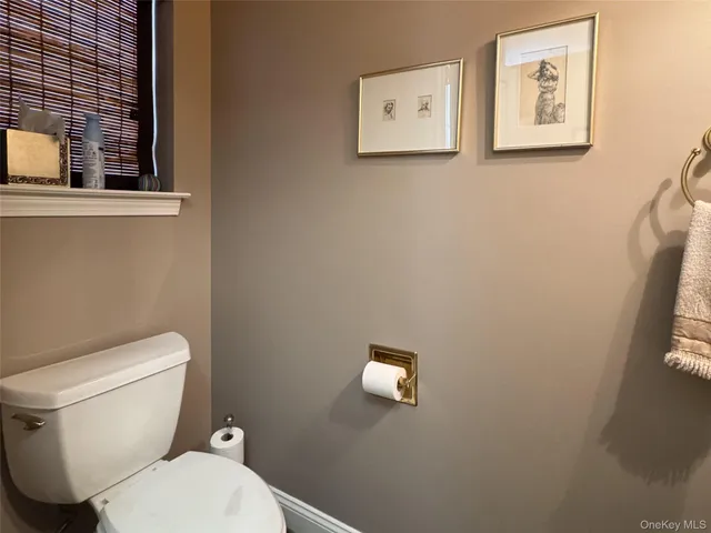 a white toilet sitting next to a bathroom sink