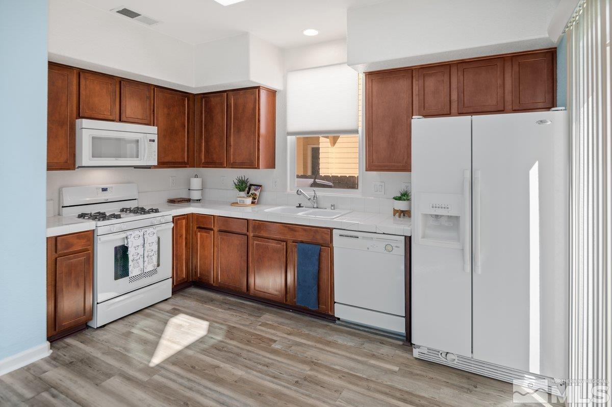 2160 Stanhope Lane Reno, NV 89502 - Photo 16 of 31 a kitchen with a white cabinets and white appliances