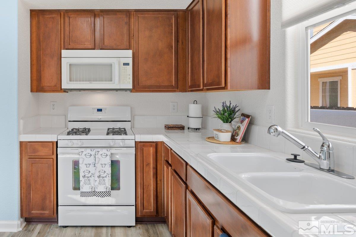 2160 Stanhope Lane Reno, NV 89502 - Photo 17 of 31 a kitchen with stainless steel appliances granite countertop a sink a stove and cabinets