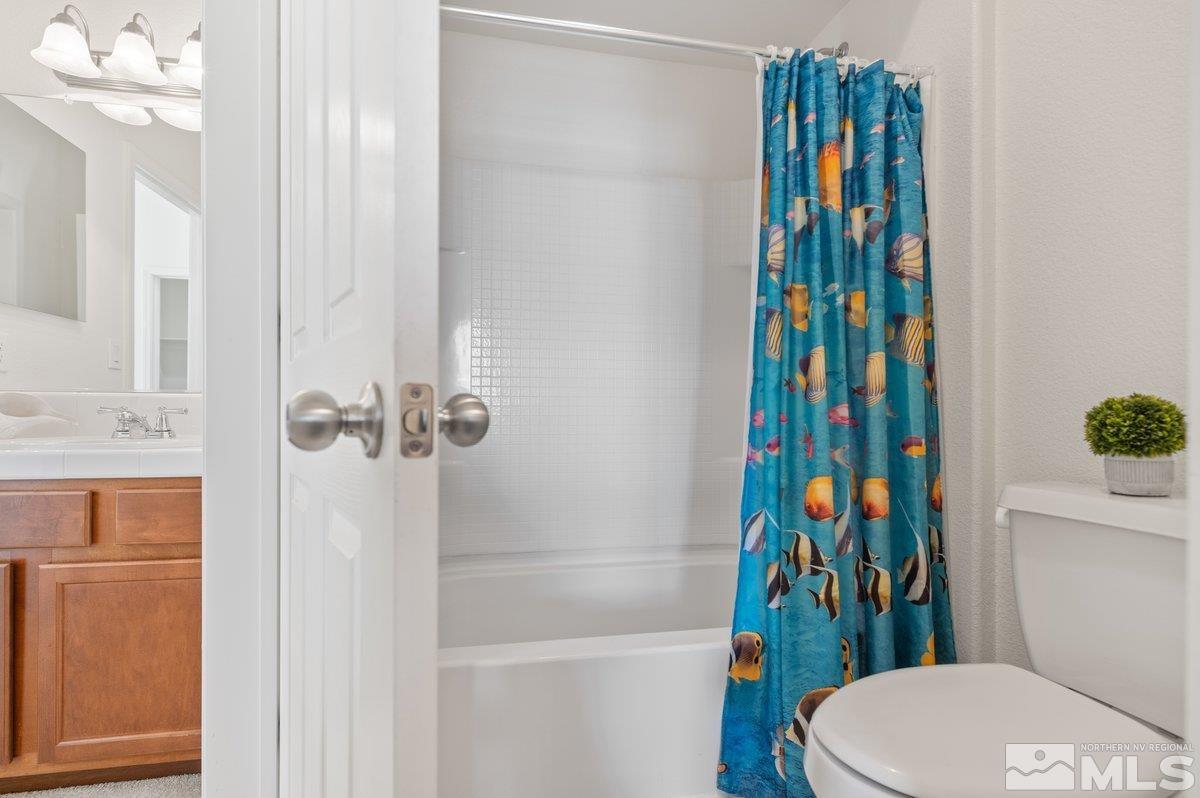 2160 Stanhope Lane Reno, NV 89502 - Photo 25 of 31 a bathroom with a sink a toilet and shower curtain