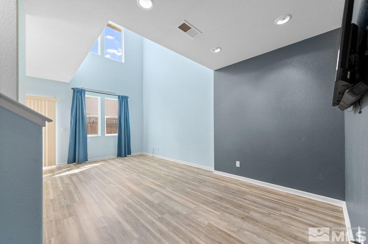 2160 Stanhope Lane Reno, NV 89502 - Photo 9 of 31 a view of an empty room with wooden floor and a window