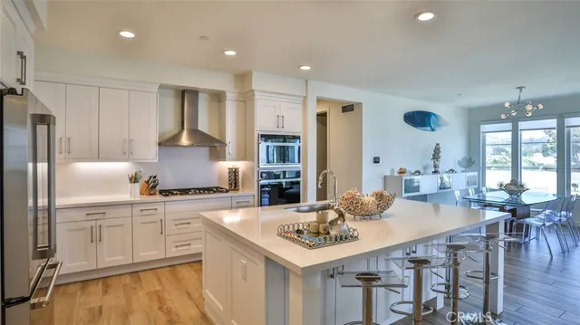 a very nice looking dining room with a large dining table and chairs