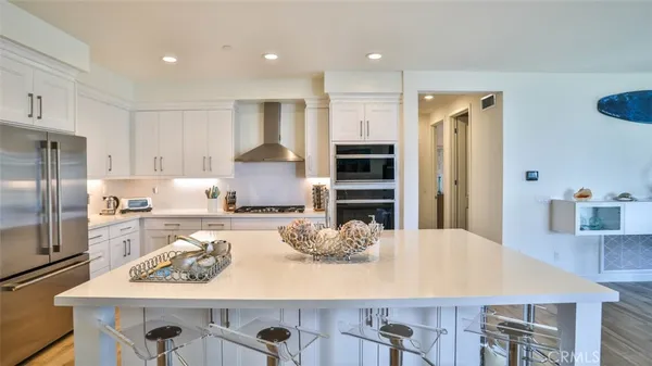 a kitchen with stainless steel appliances granite countertop a stove and a refrigerator