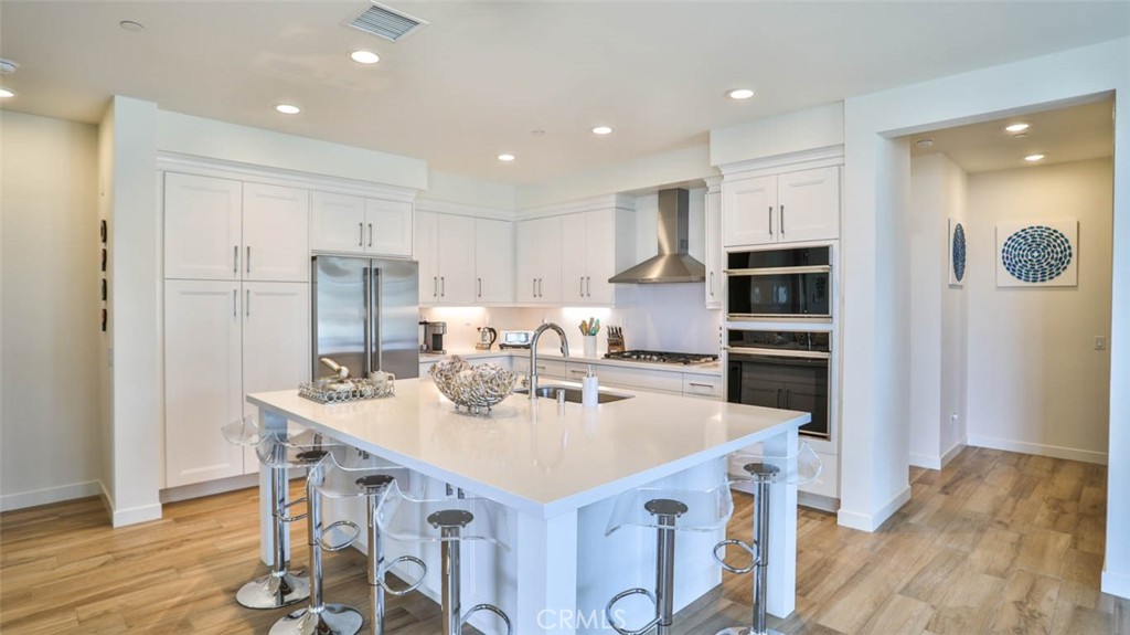 1522 Doheny Way Dana Point, CA 92629 - Photo 17 of 60 a kitchen with stainless steel appliances kitchen island granite countertop a sink and a refrigerator