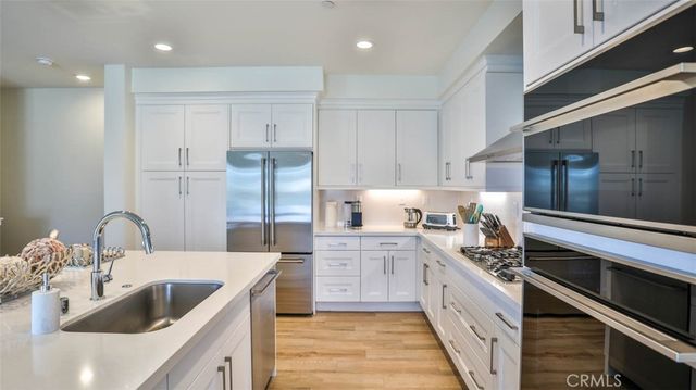 a kitchen with kitchen island granite countertop a sink and cabinets
