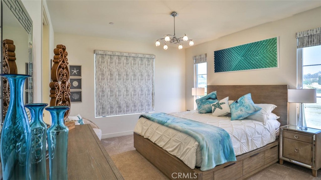 1522 Doheny Way Dana Point, CA 92629 - Photo 31 of 60 a bedroom with bed and a chandelier