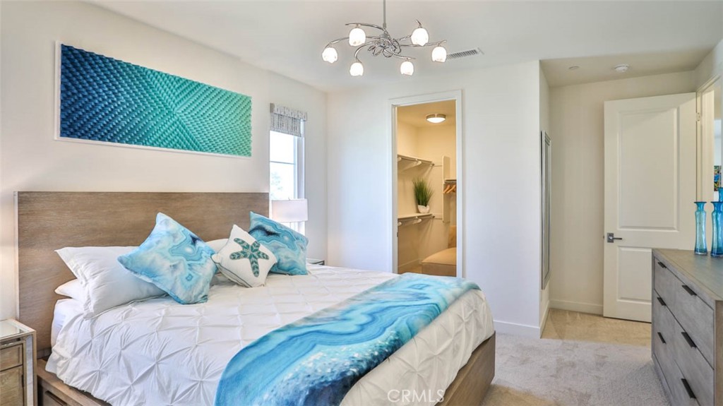 1522 Doheny Way Dana Point, CA 92629 - Photo 32 of 60 a bedroom with a bed and a chandelier