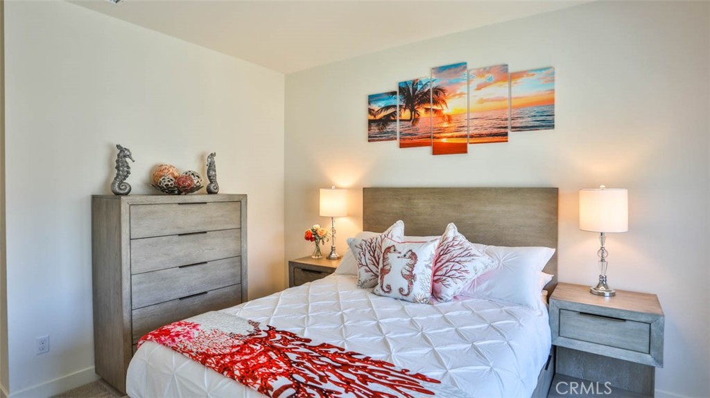 1522 Doheny Way Dana Point, CA 92629 - Photo 40 of 60 a bedroom with a bed and window