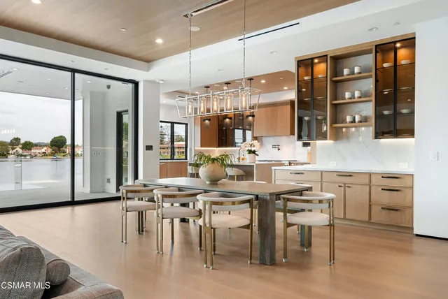 a kitchen with granite countertop a sink appliances cabinets and furniture