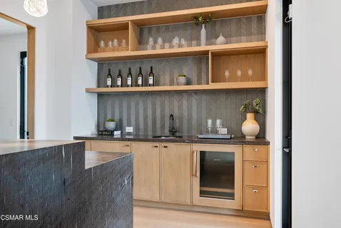 a large white kitchen with a large window