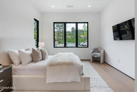 a front view of a house with a garden and plants
