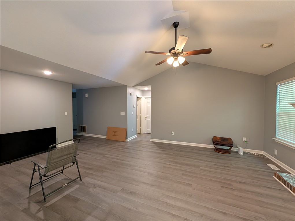 124 Woodbridge Court Anderson, SC 29621 - Photo 14 of 15 This bright and airy living area features high vaulted ceilings and durable flooring.