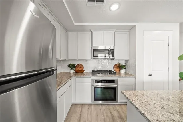 a kitchen with a stove a sink and a refrigerator