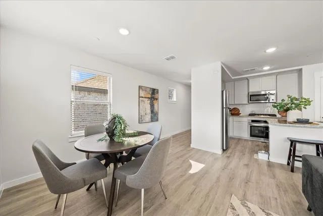 a view of a dining room with furniture and wooden floor