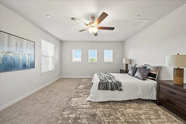 a bedroom with a large bed and a window