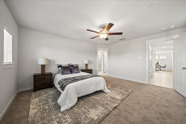a spacious bedroom with a bed and a chandelier