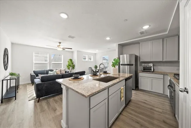 a kitchen with refrigerator and cabinets