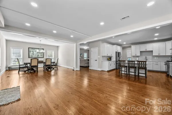 a view of kitchen and dining room with wooden floor