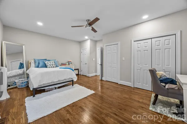 a bedroom with a bed and a chair