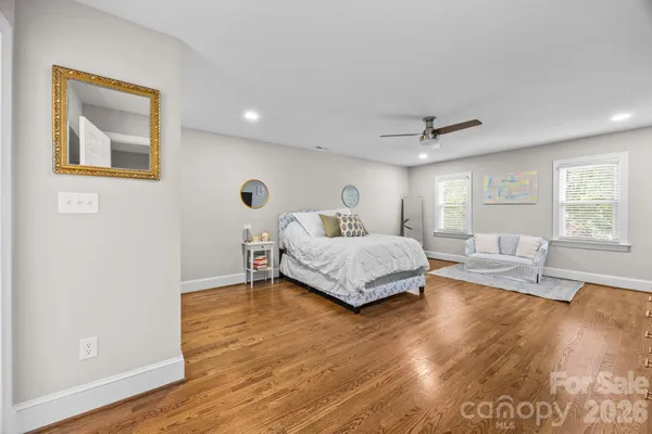 a bedroom with a bed and a large window